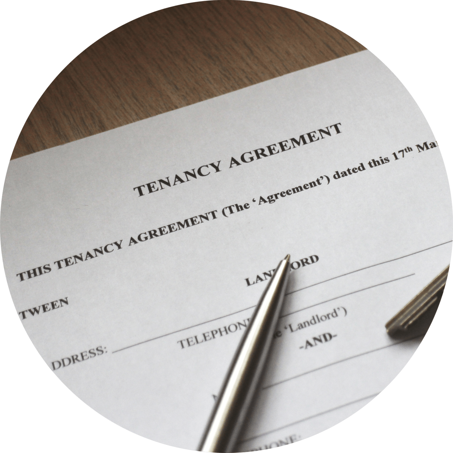 A silver pen on top of a piece of paper with the title "Tenancy Agreement".