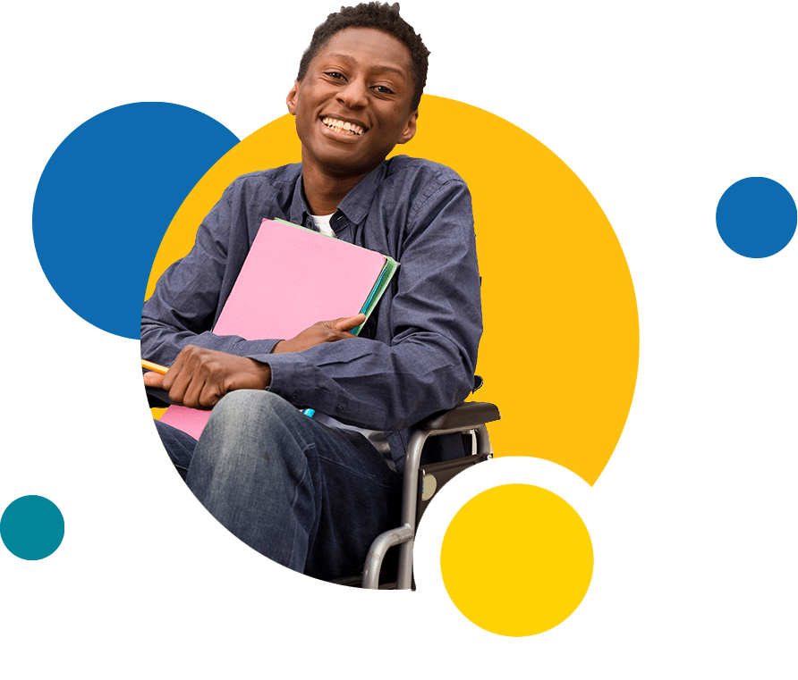 Smiling student in a wheelchair holding papers. 
